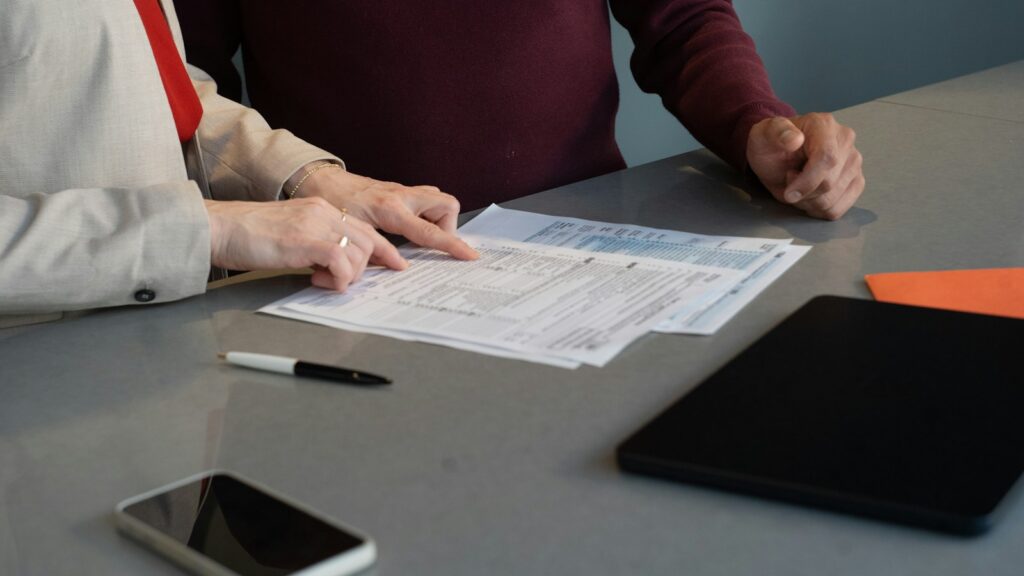 Two people reviewing estate documents at a table