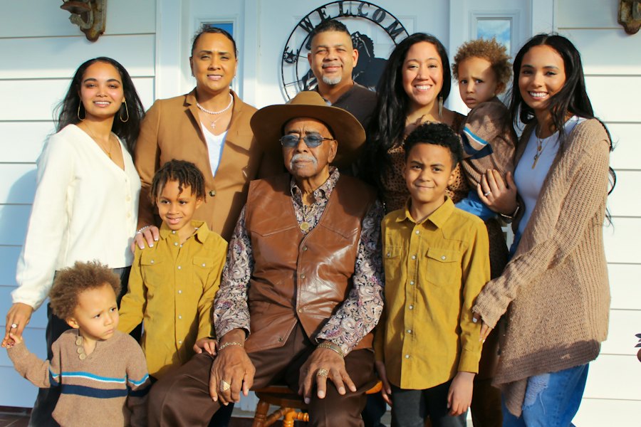 Three generations of a family together outside their home